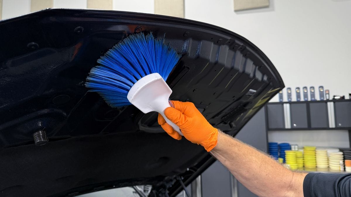 Cleaning underside of hood on car