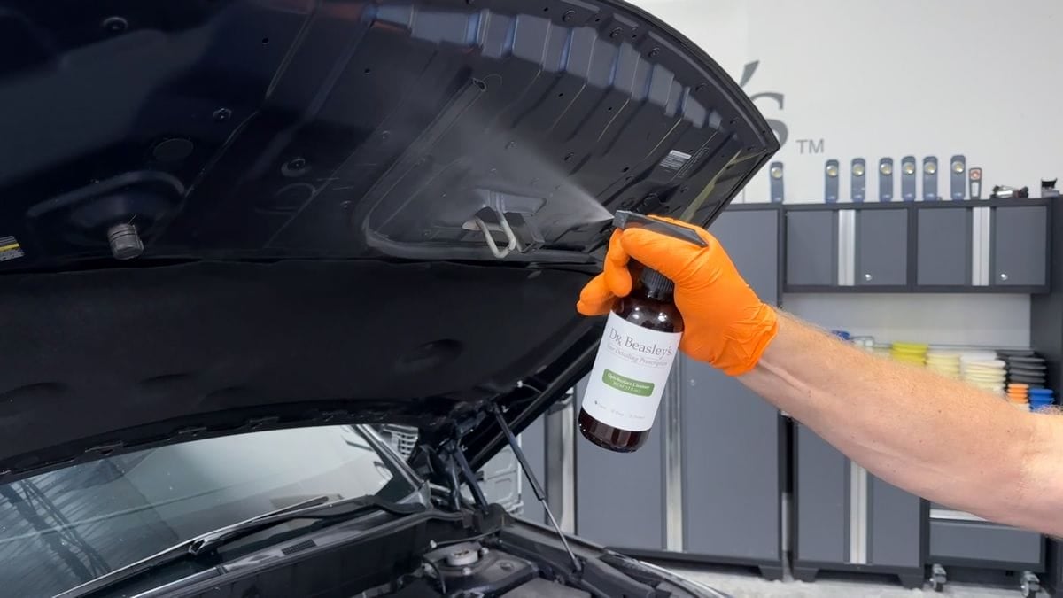 Cleaning underside of hood on car