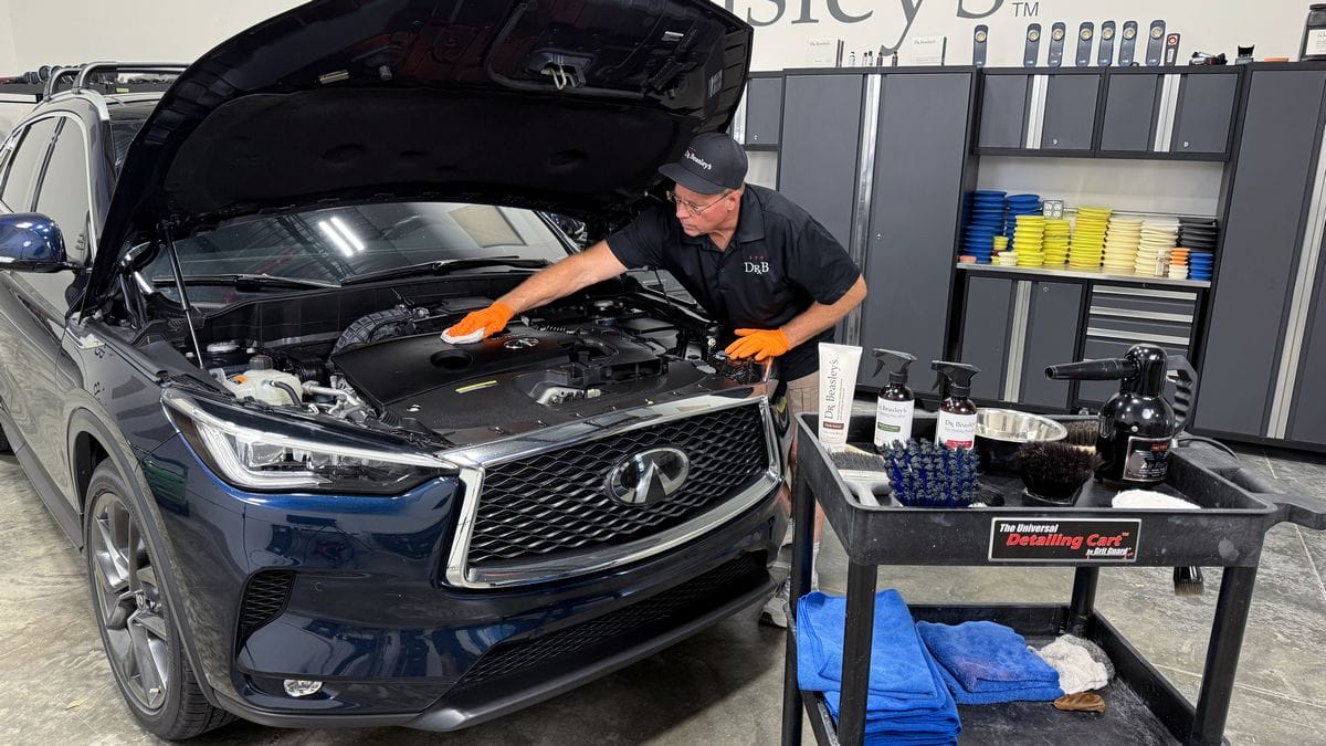 Applying plastic sealant to engine bay