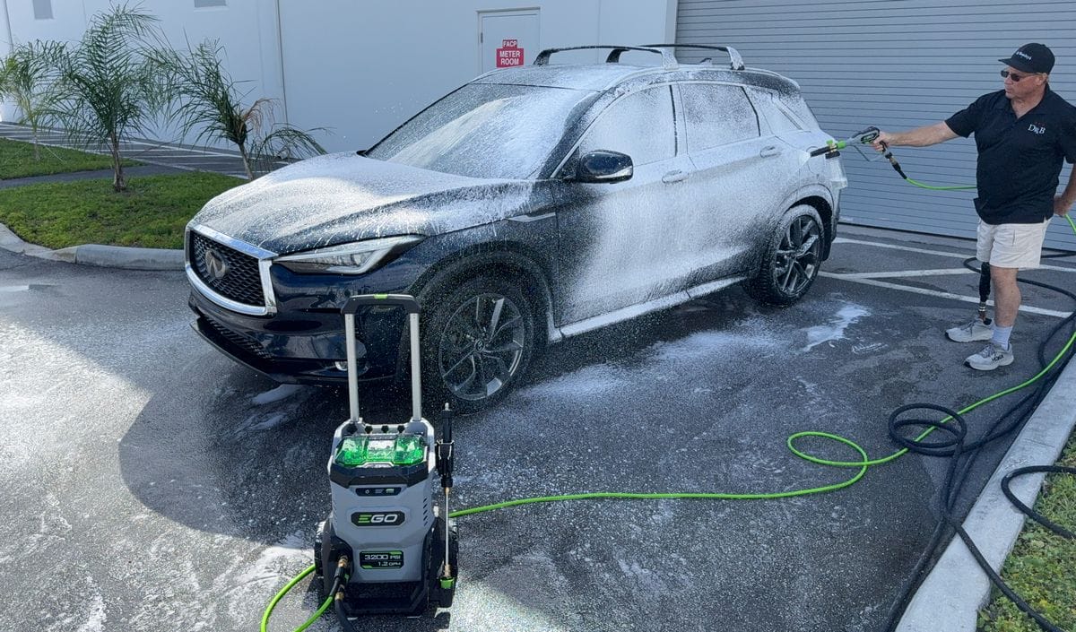 Spraying foam onto car with foam cannon