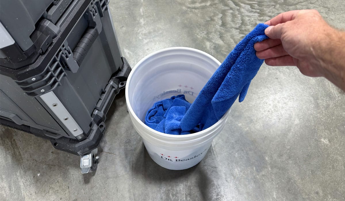 Using empty bucket as storage for used towels