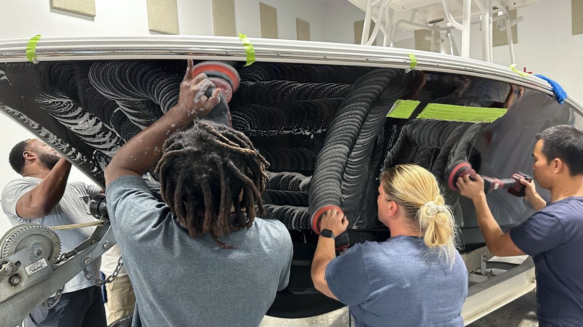 Students sanding marine gelcoat in boat detailing class