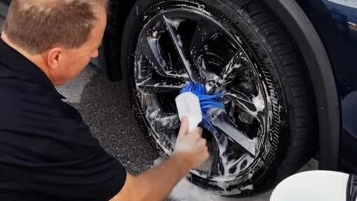 Cleaning clear coat wheels with a flagged tip wheel brush