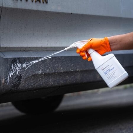 Spraying Plastic Trim with Dr. Beasley's Foaming Tire Cleanser