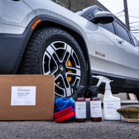 Dr. Beasley's Trim & Tire Coating Kit after use in front of a white Rivian R1S