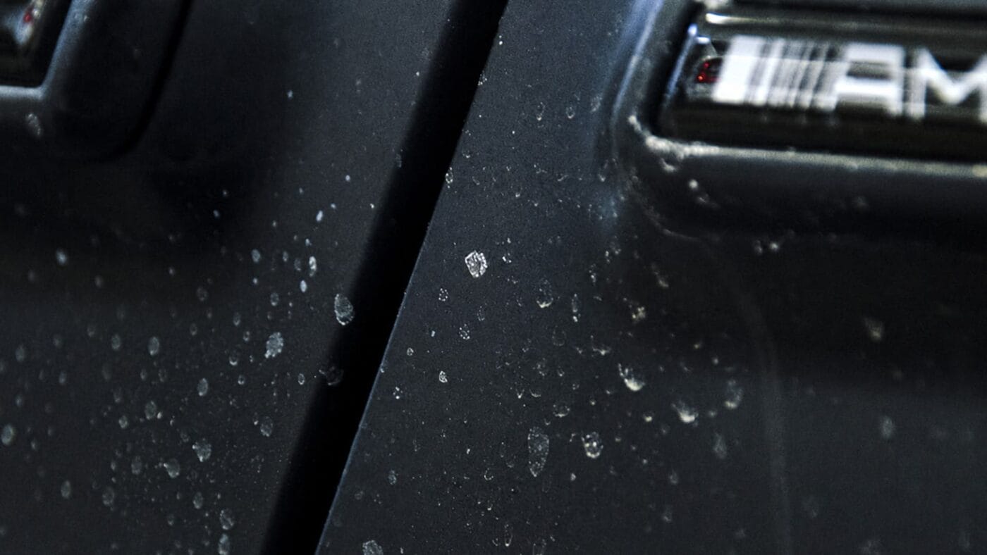 Water spots and mineral deposits on car paint after summer