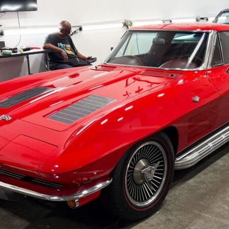 A red split-window Corvette displays a glossy finish in the Dr. Beasley’s detailing classroom.