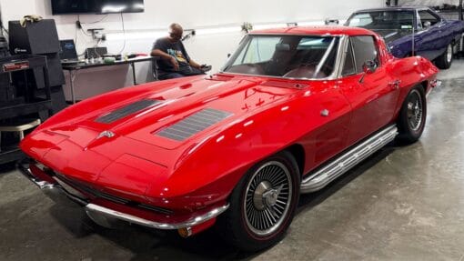 A red split-window Corvette displays a glossy finish in the Dr. Beasley’s detailing classroom.