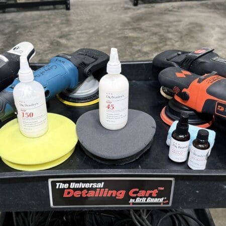 Machine polishers, polishing pads, Dr. Beasley’s NSP products, and coating bottles arranged on a detailing cart.
